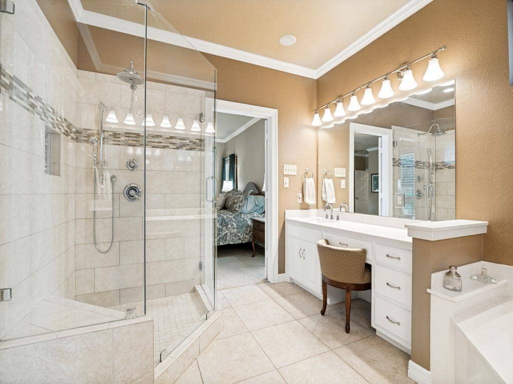 103 Texas Circle, Sunnyvale, TX 75182 The ensuite primary bathroom features tiled shower with glass surround and separate vanities.