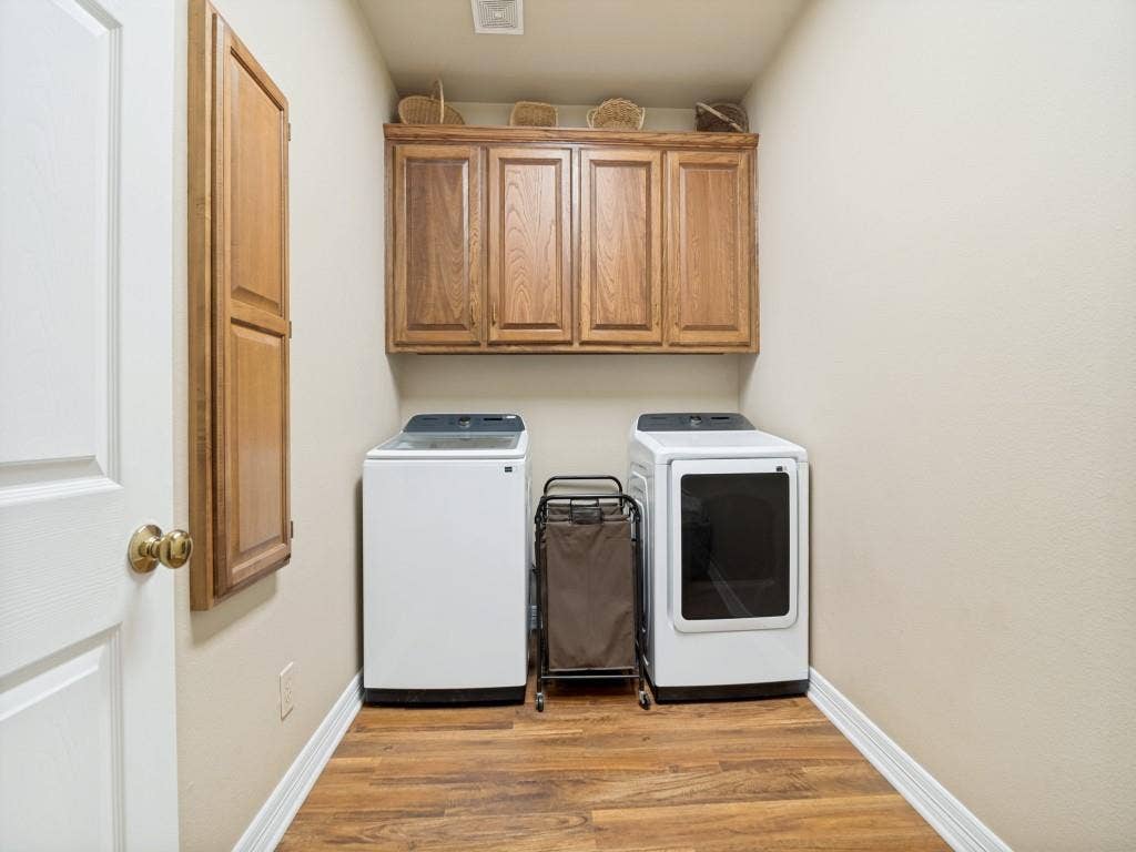103 Texas Circle, Sunnyvale, TX 75182 Laundry room with built-in cabinets and ironing board. Room for a second frig or freezer.