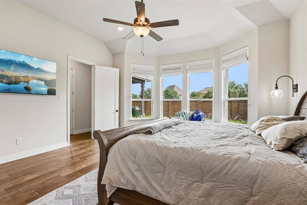 1657 Lilac Lane, Celina, TX 75009 Wood-finish flooring, vaulted ceiling, and a ceiling fan with integrated lighting