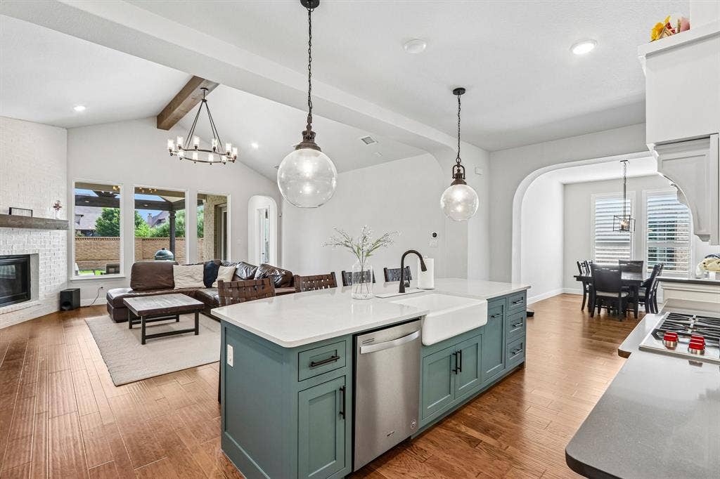 1657 Lilac Lane, Celina, TX 75009 Kitchen island with an integrated farmhouse sink, stainless steel dishwasher, and pendant lighting