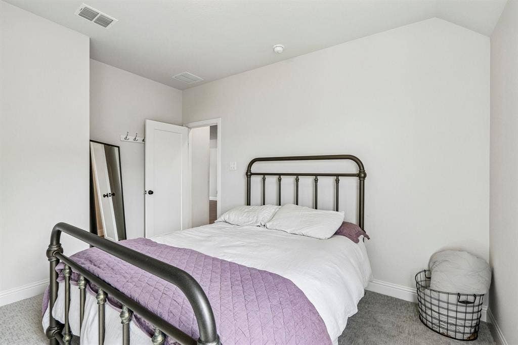 1657 Lilac Lane, Celina, TX 75009 Carpeted room with bright white walls and a white paneled door