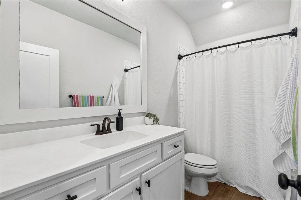 1657 Lilac Lane, Celina, TX 75009 Single vanity with white countertop, integrated sink, and bronze-finish faucet