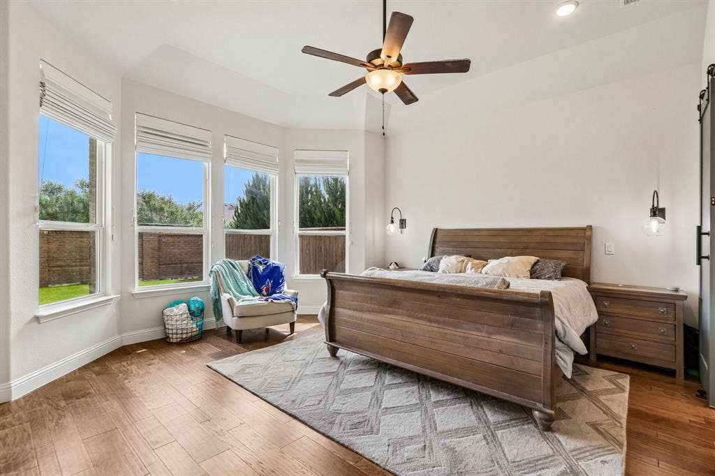 1657 Lilac Lane, Celina, TX 75009 Bay window with multiple large windows, wood-finish flooring, recessed lighting, ceiling fan, and wall-mounted sconces