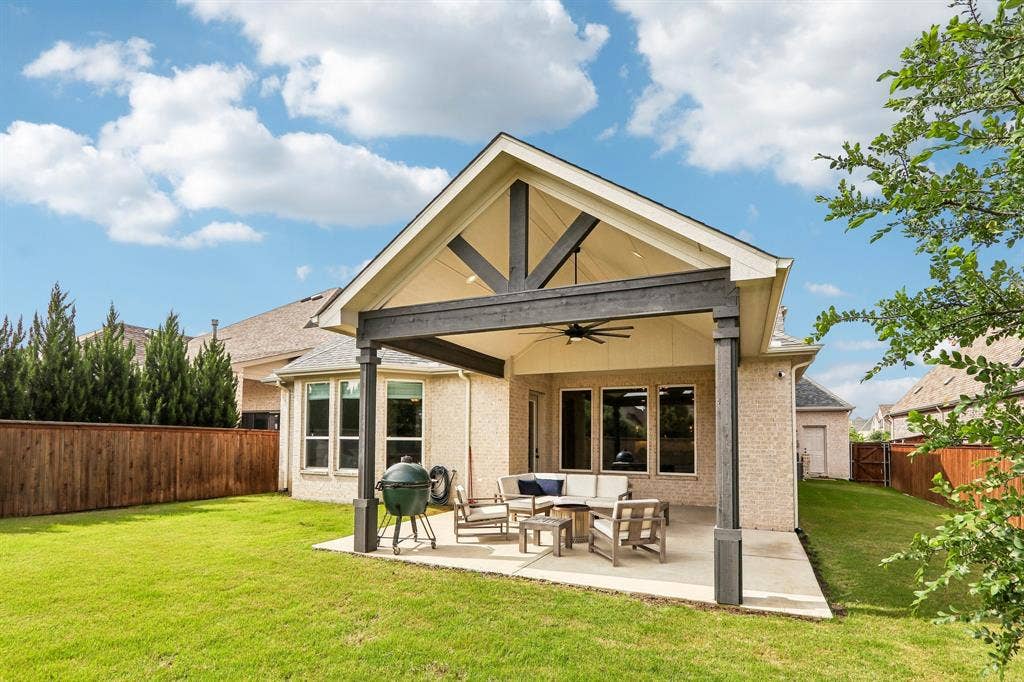 1657 Lilac Lane, Celina, TX 75009 Expansive backyard with a covered patio, vaulted ceiling, and ceiling fan