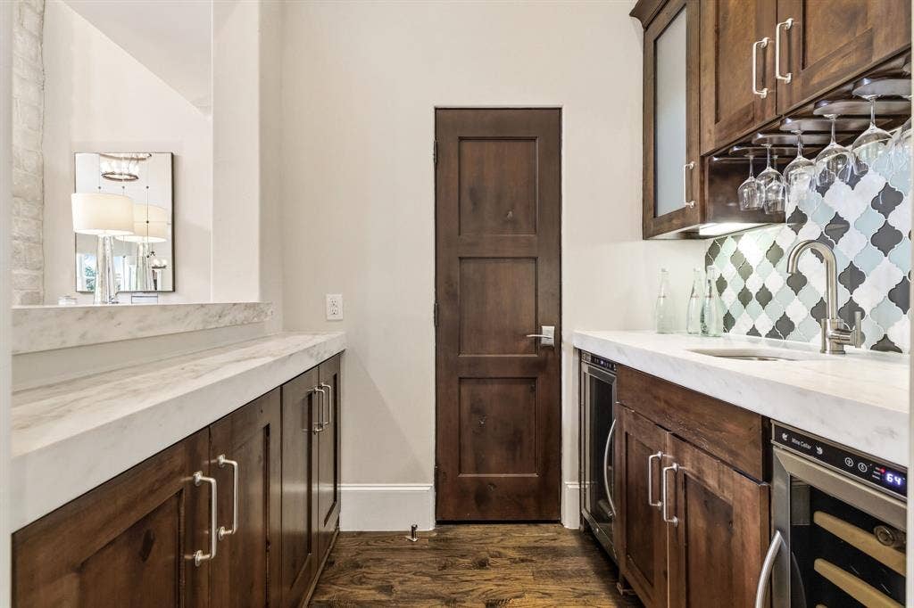 6635 Park Lane, Dallas, TX 75225 Wet bar featuring a wine fridge, beverage fridge and storage. Temperature controlled wine storage also featured in this home.