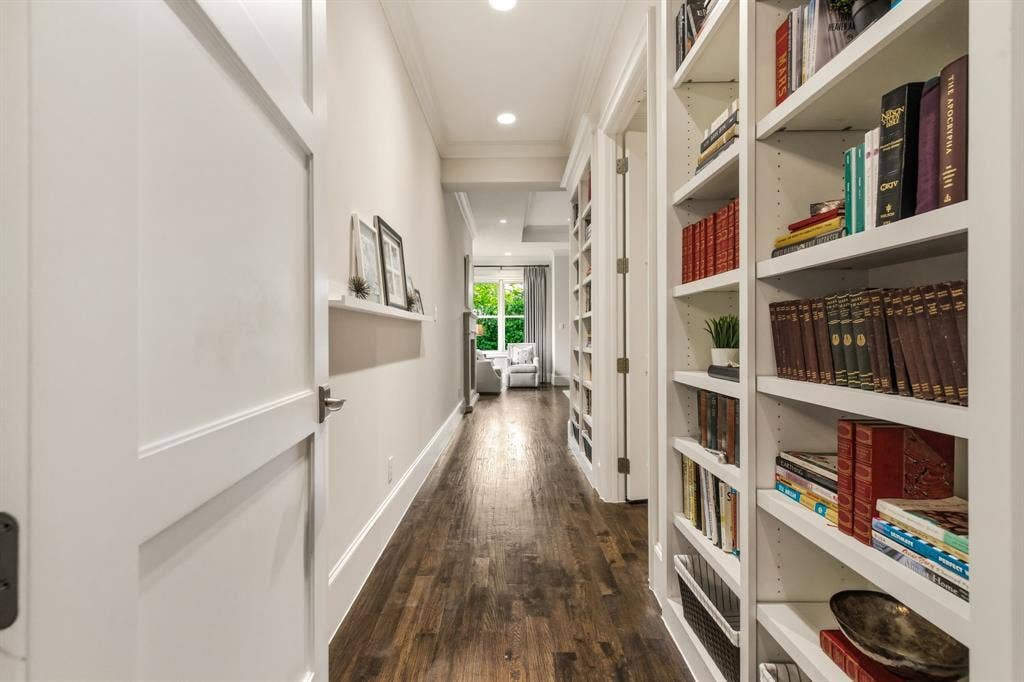 6635 Park Lane, Dallas, TX 75225 Hallway and bookshelves leading into primary bedroom.