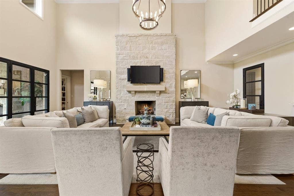 6635 Park Lane, Dallas, TX 75225 Stone fireplace with gas logs centered in this expansive living room.