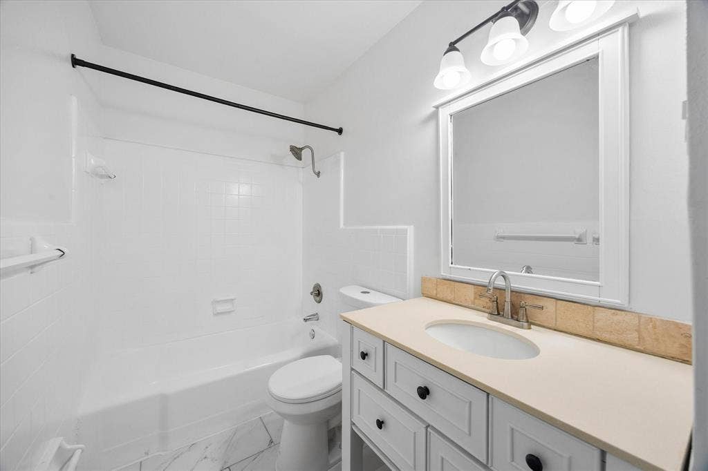 4011 Cole Avenue, #111, Dallas, TX 75204 Full bathroom with vanity and tub/shower combination.