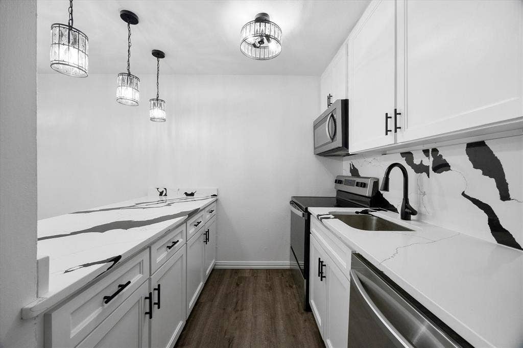 4011 Cole Avenue, #111, Dallas, TX 75204 Original updated kitchen featuring white cabinetry, matte black hardware, soft close drawers, and generous storage.