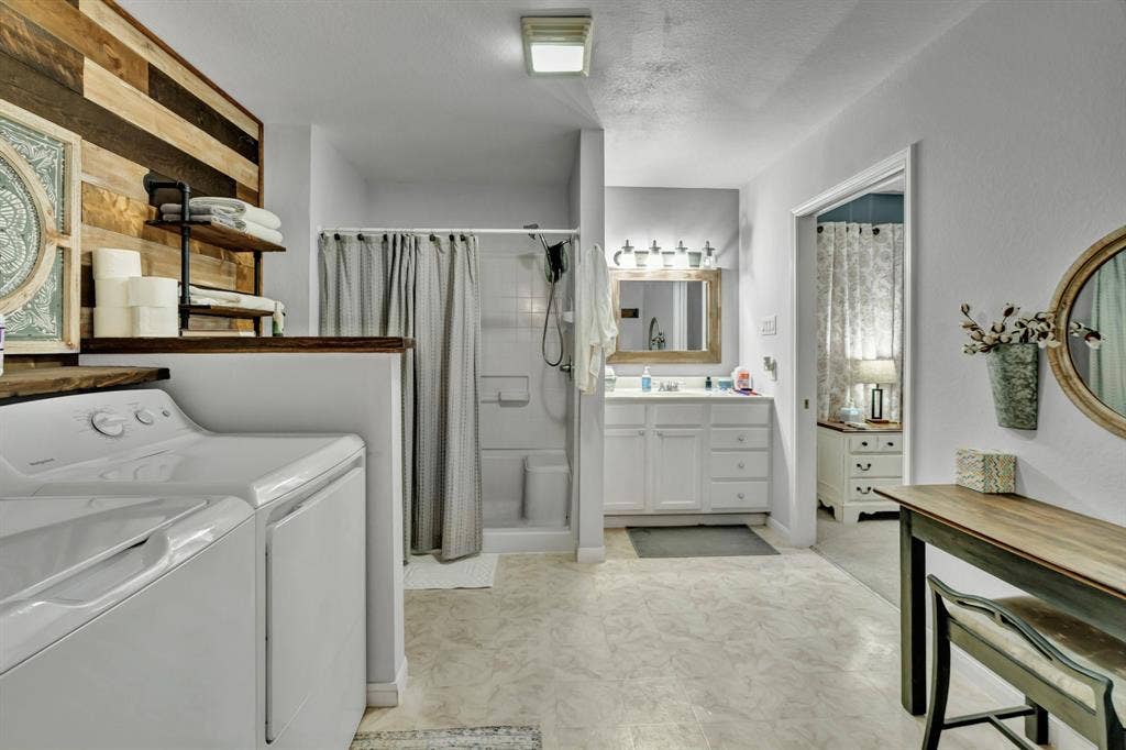 6155 Stephenson Levy Road, Fort Worth, TX 76140 Large bathroom with walk-in shower and washer - dryer