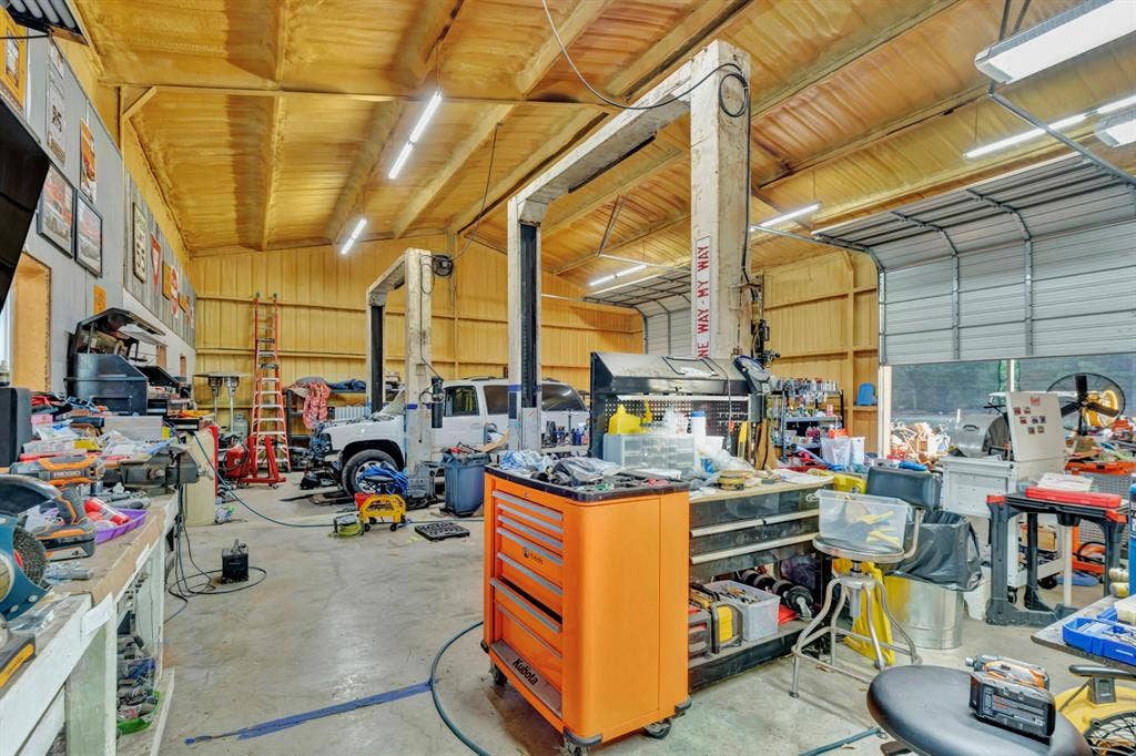 6155 Stephenson Levy Road, Fort Worth, TX 76140 Huge shop shown with 2 car lifts and roll top doors
