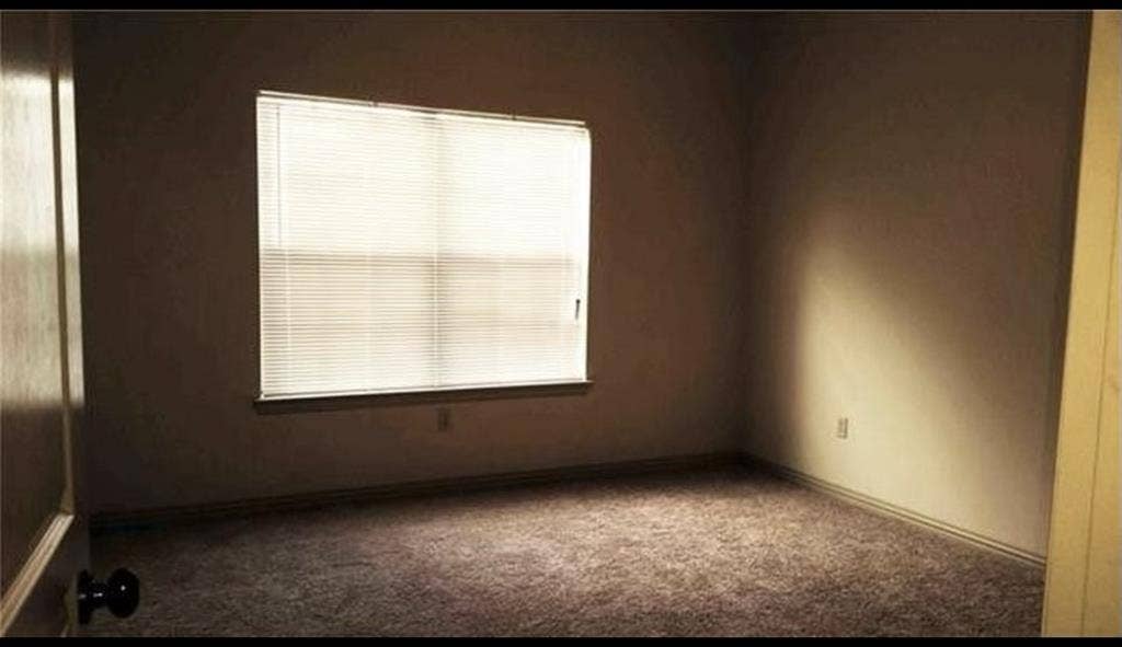 3713 Pearl Trail, Garland, TX 75044 Room featuring a window with horizontal blinds and textured carpeting