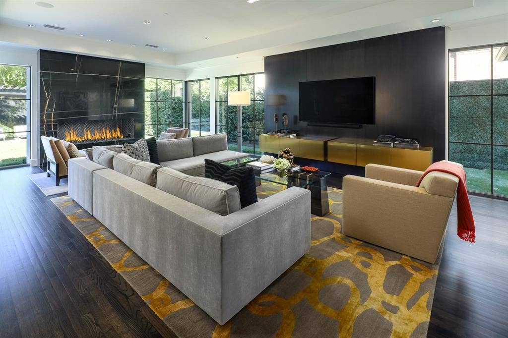 6039 Waggoner Drive, Dallas, TX 75230 Family Room with gas fireplace and floor to ceiling windows overlooking backyard