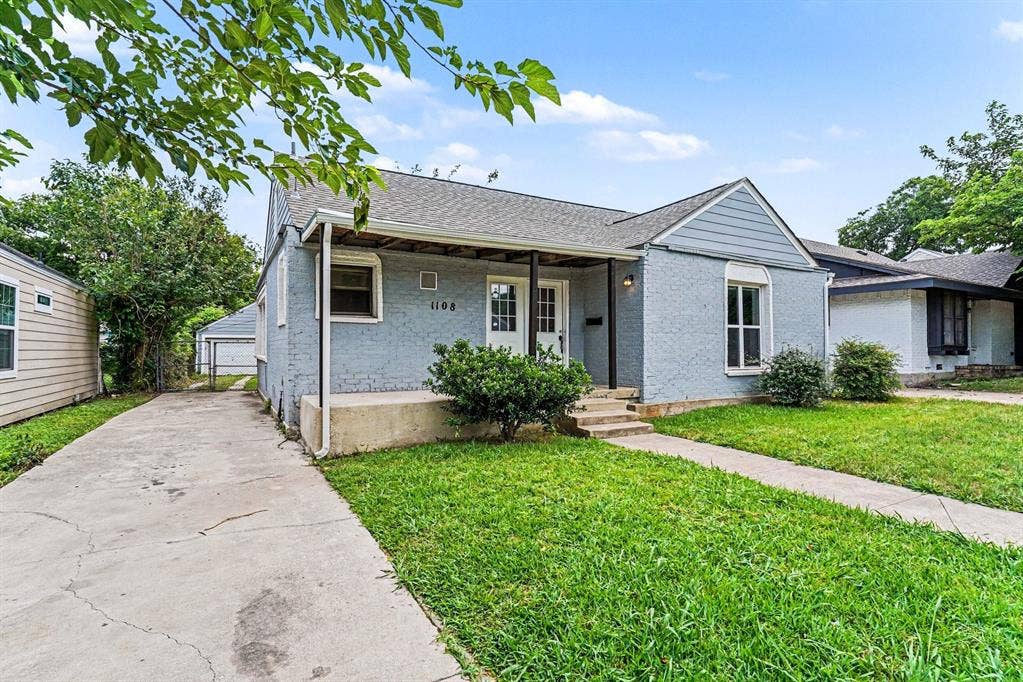 1108 E Robert Street, Fort Worth, TX 76104 Traditional exterior with a covered porch, an attached carport, a concrete driveway, and established front landscaping