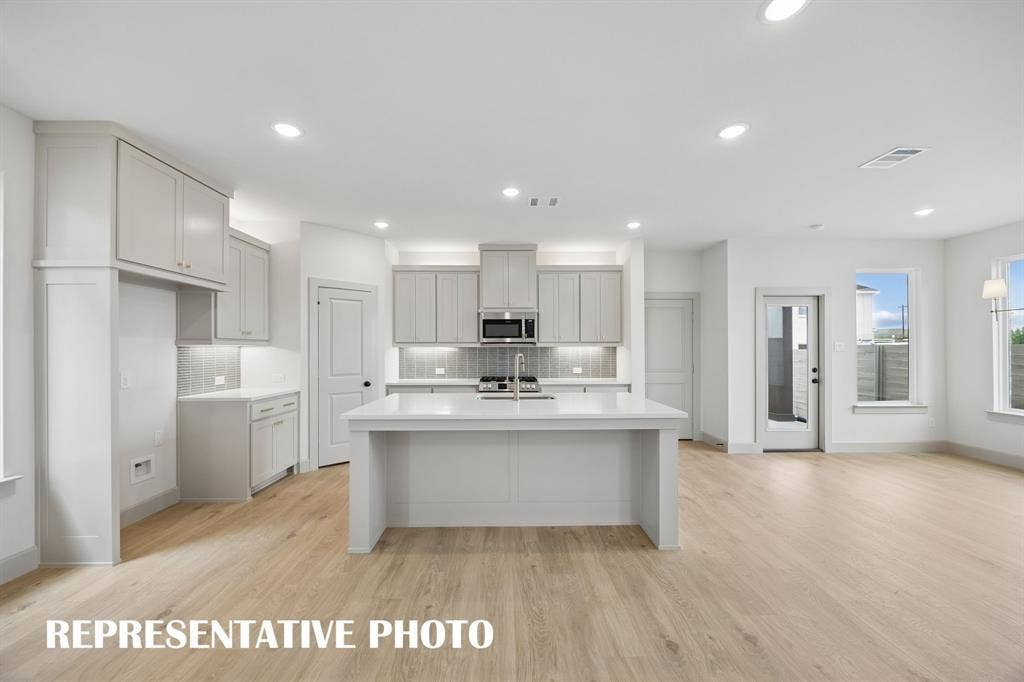 4608 Reveille Drive, McKinney, TX 75071 The spacious kitchen island offers the ideal place for family and friends to gather round. REPRESENTATIVE PHOTO