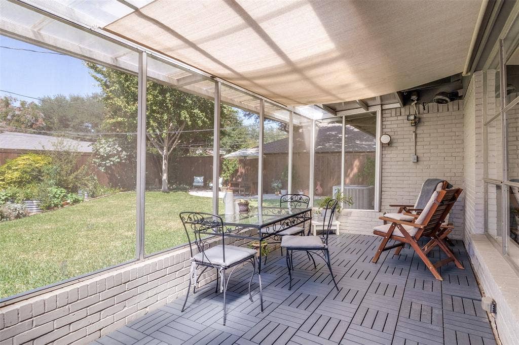 6719 Braeburn Drive, Dallas, TX 75214 Screened patio featuring a solid roof, brick base, and slatted flooring