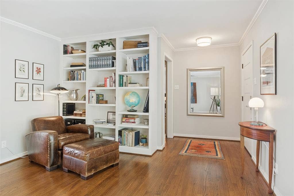6719 Braeburn Drive, Dallas, TX 75214 Original Hardwood floors, built-in shelving, crown molding, and a framed mirror