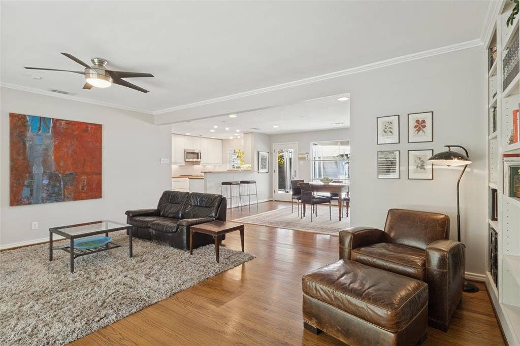 6719 Braeburn Drive, Dallas, TX 75214 Original Hardwood floors flooring throughout, crown molding, and a ceiling fan with integrated lighting