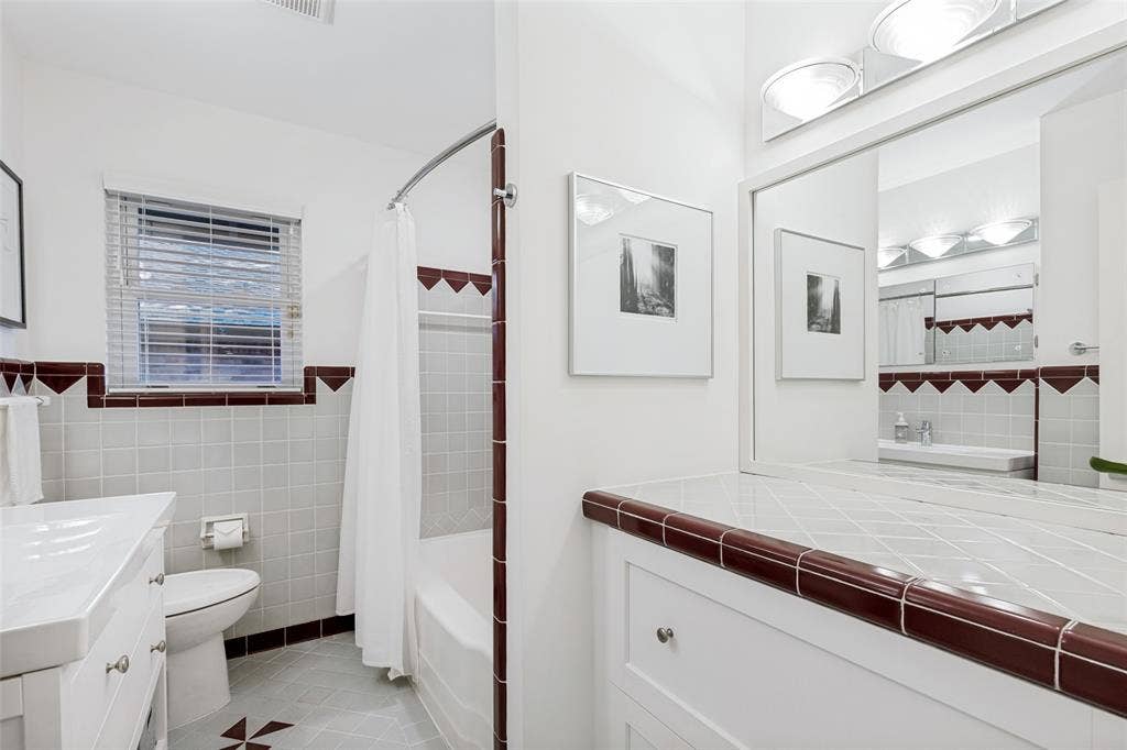 6719 Braeburn Drive, Dallas, TX 75214 White tile flooring with decorative brown accents