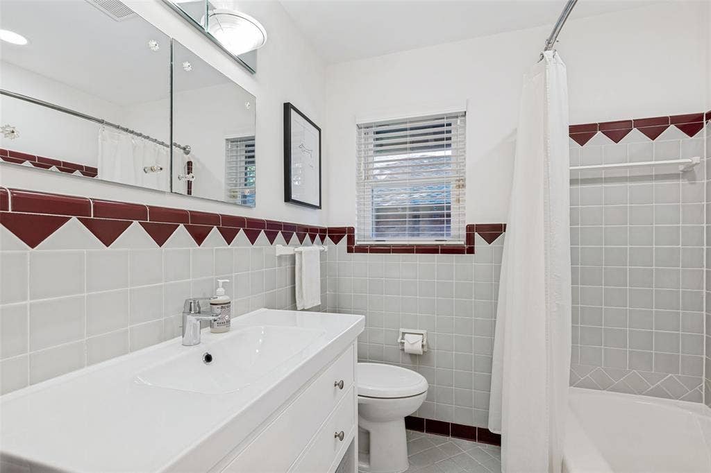 6719 Braeburn Drive, Dallas, TX 75214 Full bathroom featuring a single vanity, integrated sink, mirrored medicine cabinet, and a shower-tub combination