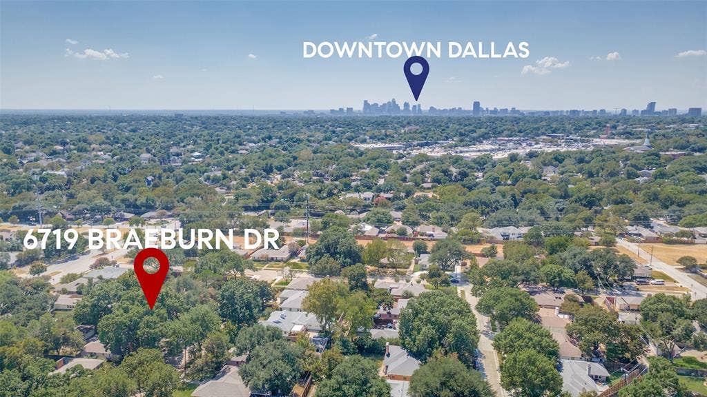 6719 Braeburn Drive, Dallas, TX 75214 Aerial perspective of a tree-lined residential area with urban skyline in the distance