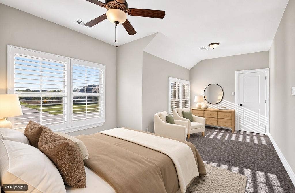 6010 Limestone Lane, Midlothian, TX 76065 Vaulted ceiling, ceiling fan, white paneled door, shuttered windows, and textured carpet flooring