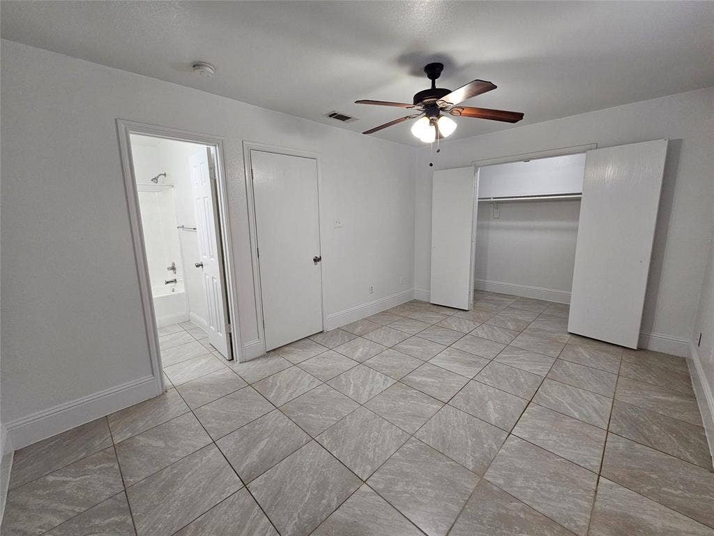 1615 Herald Street, #1613, Dallas, TX 75215 Tiled flooring throughout, ceiling fan with integrated lighting, and a closet with bi-fold doors