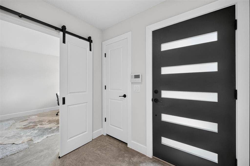 Modern Entry door with flex room with barn doors