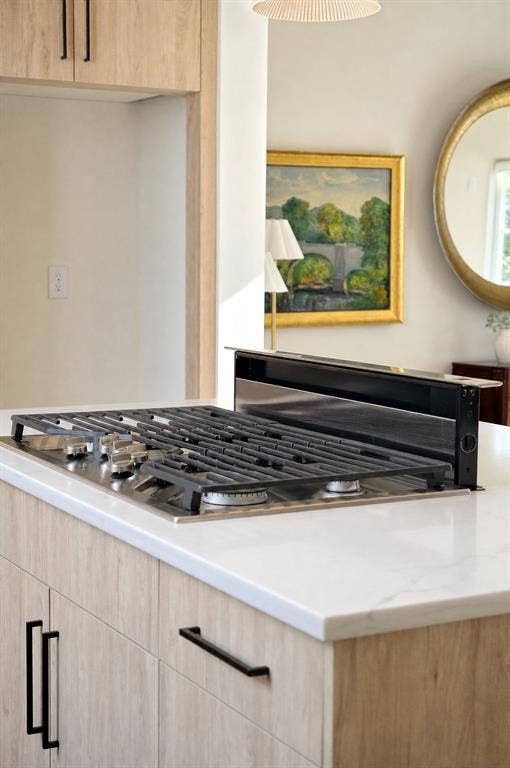 GE cafe series gas cooktop with downdraft ventilation to outside