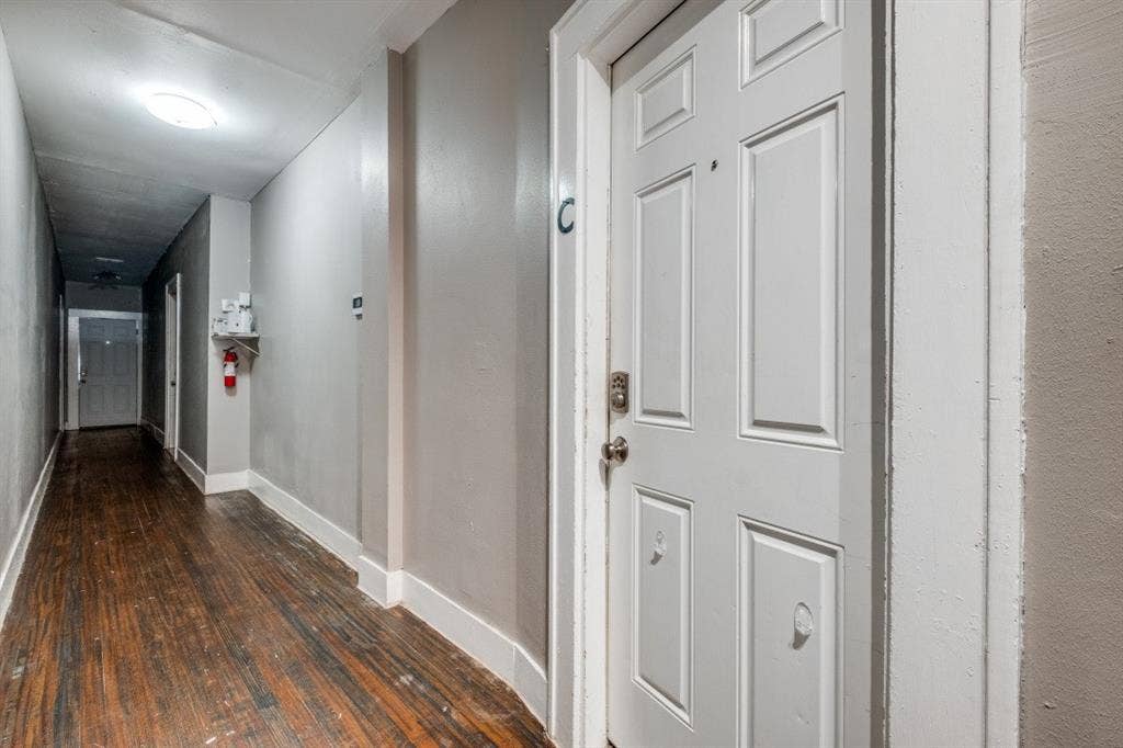 804 Sunset Avenue, #C, Dallas, TX 75208 Entry door with paneling, metal hardware, and white trim