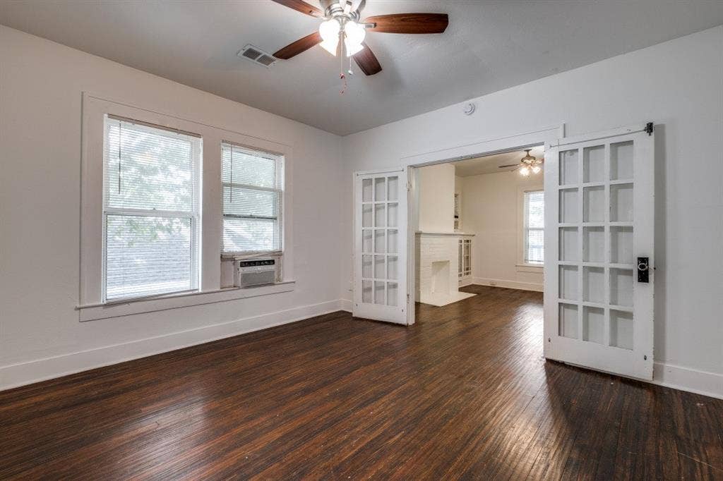 804 Sunset Avenue, #C, Dallas, TX 75208 Dark wood-finish flooring, white walls, ceiling fan with light fixture, and white French doors with dark hardware