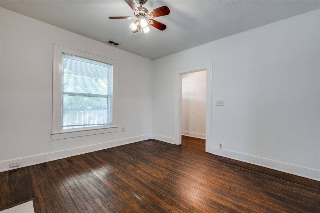 804 Sunset Avenue, #C, Dallas, TX 75208 Hardwood flooring, painted walls, ceiling fan with light fixture, and window with white trim
