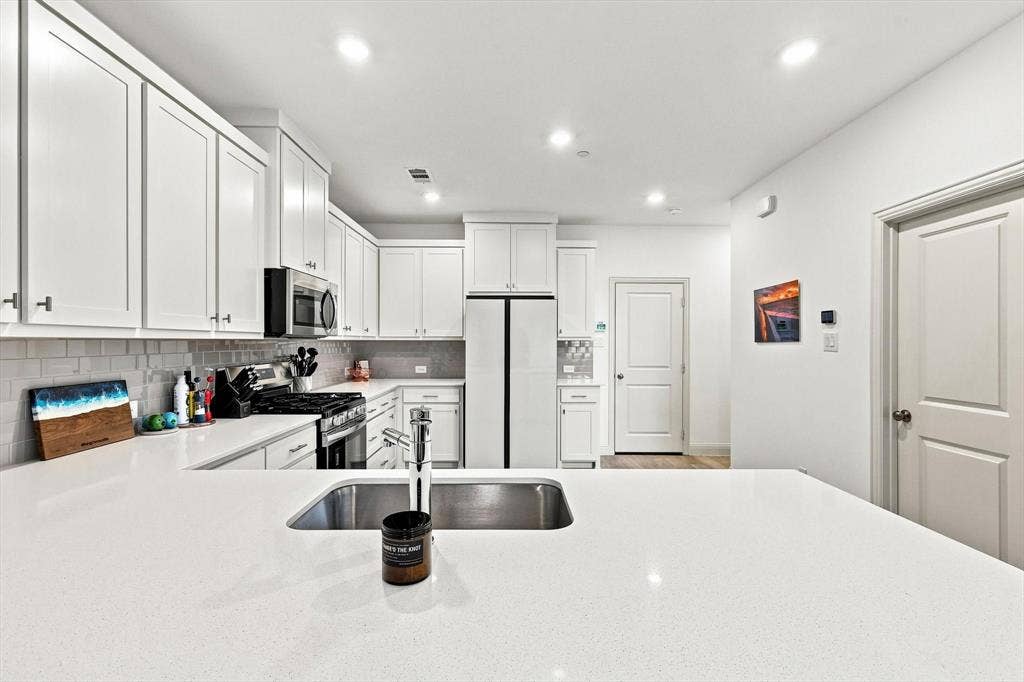 4833 Lunker Street, McKinney, TX 75071 A kitchen that delivers on both style and function, with generous counter space, abundant cabinetry, stainless appliances, and an oversized island ready for entertaining.