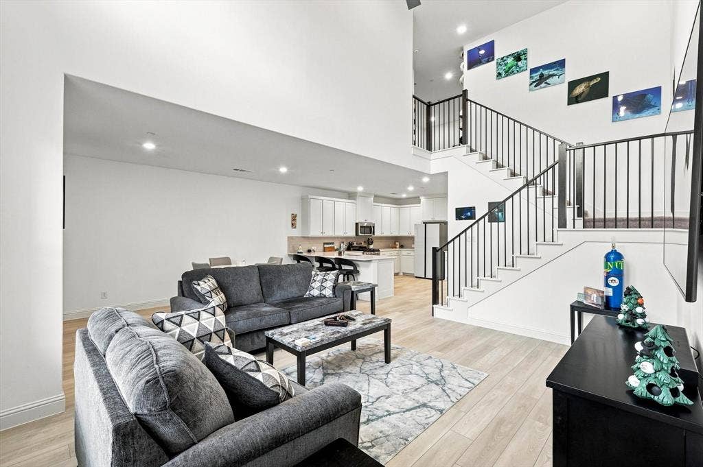 4833 Lunker Street, McKinney, TX 75071 Designed to impress and made for everyday living—the dramatic living room flows seamlessly into the kitchen and dining areas for effortless entertaining.