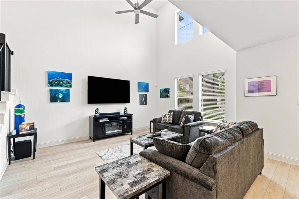 4833 Lunker Street, McKinney, TX 75071 This is the wow moment. Soaring ceilings, incredible natural light, and an airy two-story design make this living room the showpiece of the home.