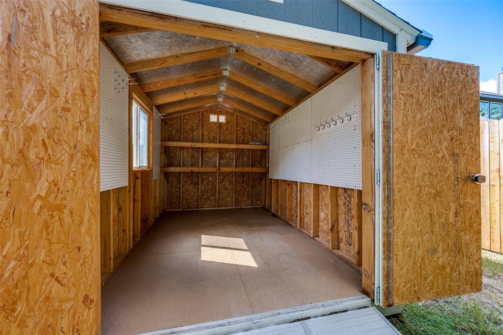 6001 Allison Drive, Midlothian, TX 76065 Cedar panels and peg boards add to the functionality of the storage shed.