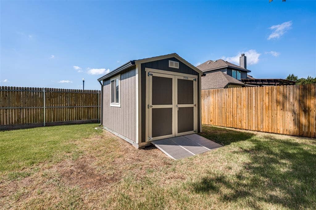 6001 Allison Drive, Midlothian, TX 76065 Top quality Tuff Shed for storing your lawn mower and tools was painted to match the main house. It has gutters, a window and sits off the ground on a metal foundation. Notice the oversized ramp for easier access.