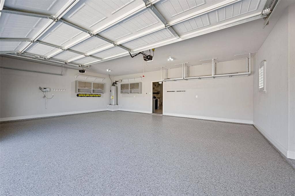 6001 Allison Drive, Midlothian, TX 76065 A beautiful epoxy-coated floor, overhead storage racks, and multiple windows shout first-class in this 3-car garage.