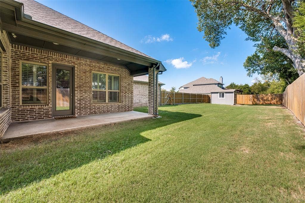 6001 Allison Drive, Midlothian, TX 76065 Enjoy your large backyard from the covered patio. The house sits on approximately 1/3 of an acre.