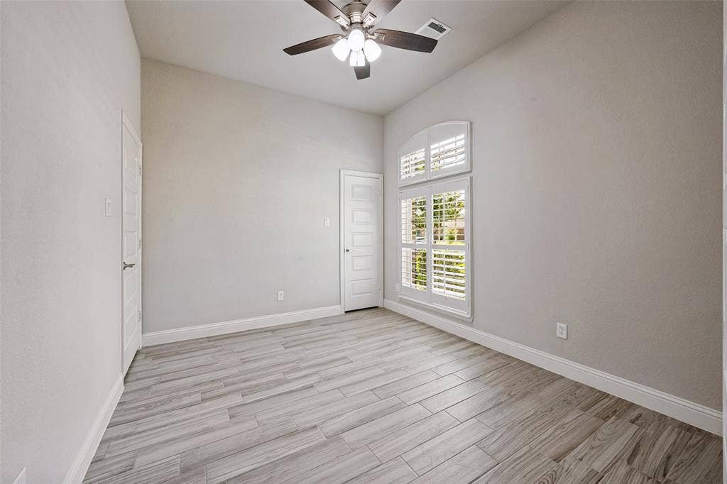 6001 Allison Drive, Midlothian, TX 76065 The office features a tall ceiling with a ceiling fan, light gray walls, wood-look tile flooring and a window with plantation shutters. Also feautured is a walk-in closet to store your supplies or turn it into a 5th bedroom.