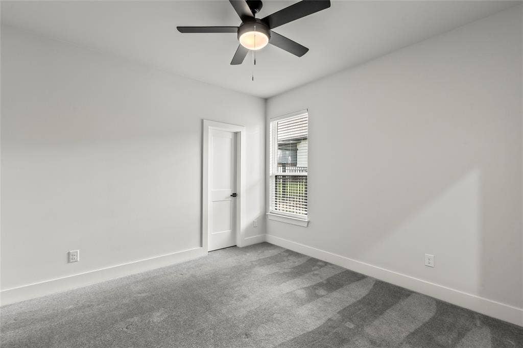 128 Saint Andrews Drive E, Mabank, TX 75156 White walls with grey carpet, a white door, and a single window with blinds