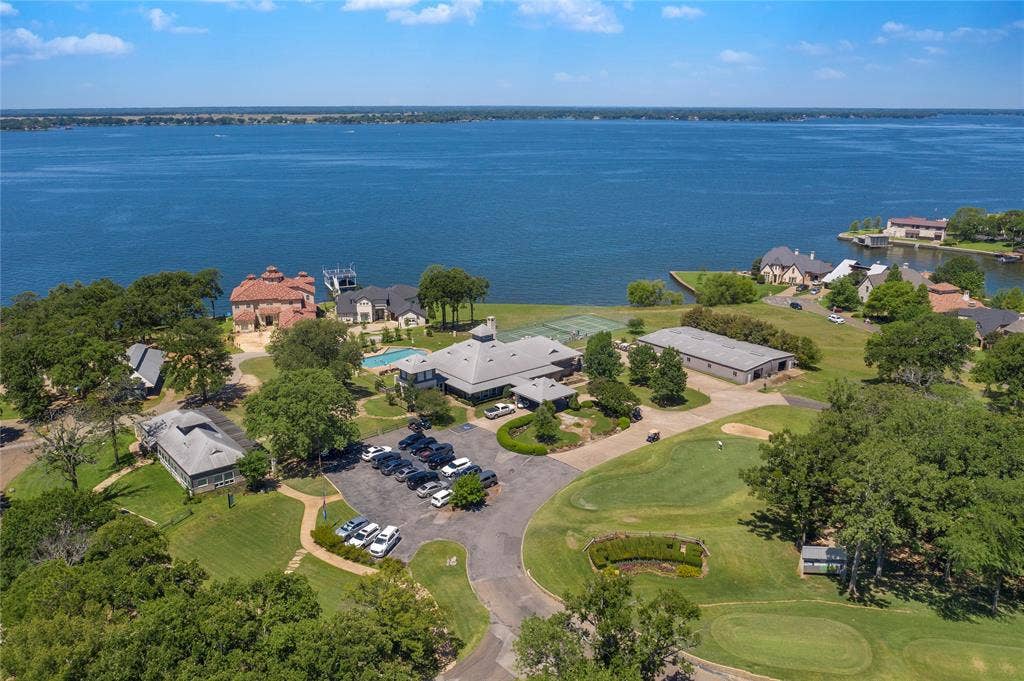 128 Saint Andrews Drive E, Mabank, TX 75156 Expansive waterfront property featuring a large body of water, extensive green spaces, and multiple structures