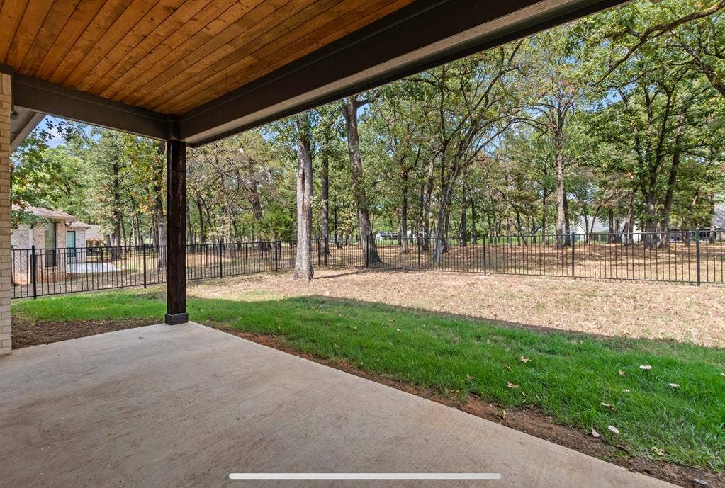 128 Saint Andrews Drive E, Mabank, TX 75156 Expansive covered patio with a wood-finish ceiling, exposed beam, and concrete flooring
