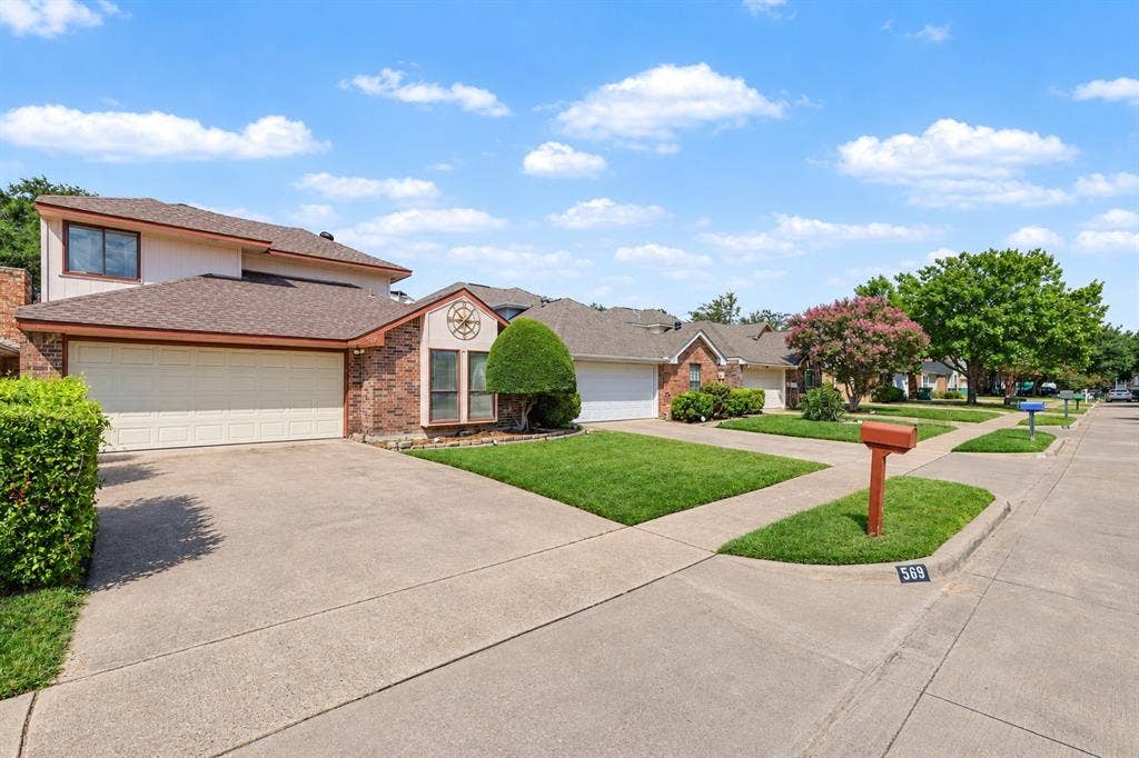 Brick and siding exterior with an attached two-car garage