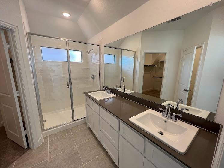 1408 Rendyn Street, Anna, TX 75409 Bathroom featuring a double vanity with white cabinetry, dark countertops, and chrome fixtures