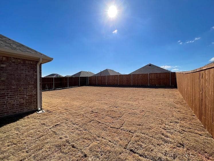 1408 Rendyn Street, Anna, TX 75409 Expansive backyard with a full privacy fence and brick exterior