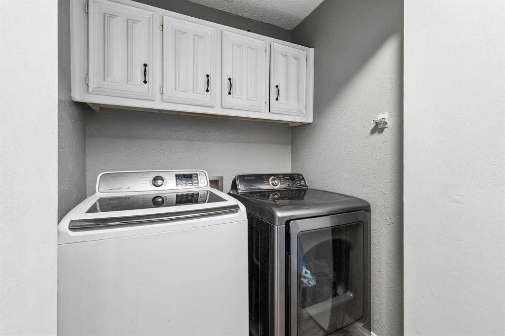 White upper cabinetry with black hardware