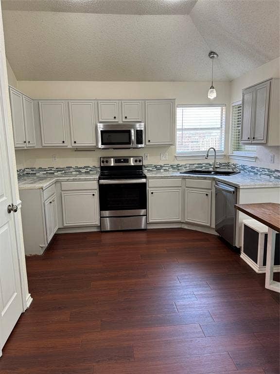 1025 Boardwalk Street, Midlothian, TX 76065 Kitchen with sink, dishwasher, dark wood-type flooring, hanging light fixtures, and stainless steel range with electric stovetop