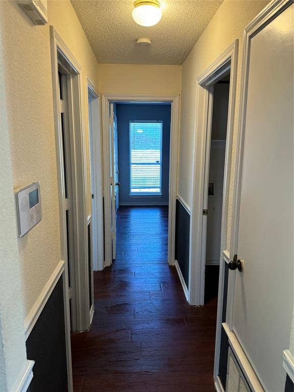 1025 Boardwalk Street, Midlothian, TX 76065 Corridor with dark hardwood / wood-style floors and a textured ceiling