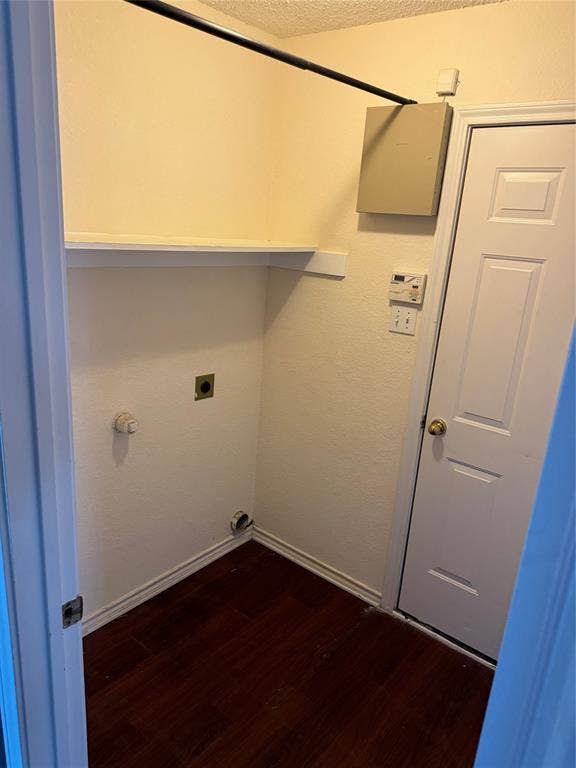 1025 Boardwalk Street, Midlothian, TX 76065 Clothes washing area with hookup for an electric dryer, dark hardwood / wood-style flooring, and a textured ceiling